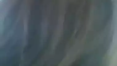 A guy presses a girl’s boobs outdoors in the local sex video