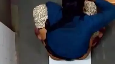 Indian girl changing pad in toilet
